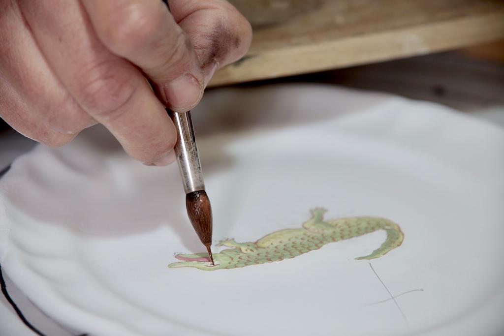 Artisan painting a crocodile