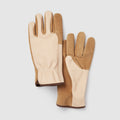 A product photograph of a pair of high-end two-toned gardening gloves, displayed flat side-by-side against a clean, light gray square background. The gloves feature a premium cream-colored smooth leather on the palms and inner fingers, contrasted with a rugged tan-brown suede on the backs of the hands, cuffs, and fingertips. A subtle elastic gathered detail is visible at the wrist, and the edges are finished with a clean brown trim.