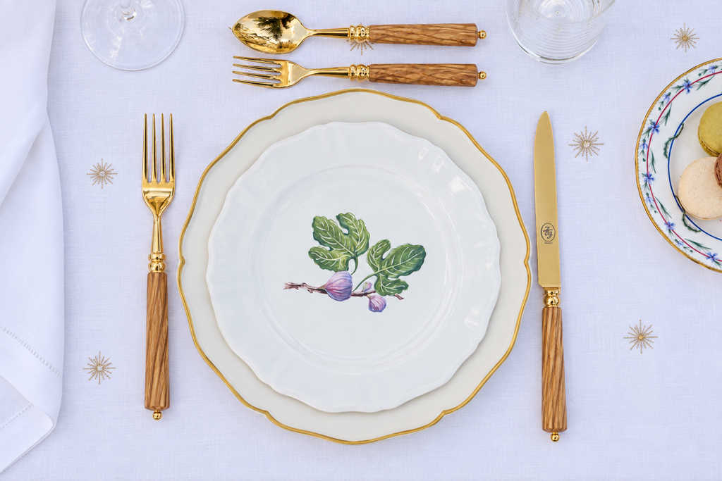 Z.d.G. Le Potager du Roi Stardust embroidered white linen tablecloth set on an outdoor table with desserts and wheat sheaves.