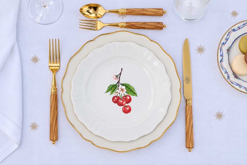 Z.d.G. Le Potager du Roi Stardust embroidered white linen tablecloth set on an outdoor table with desserts and wheat sheaves.